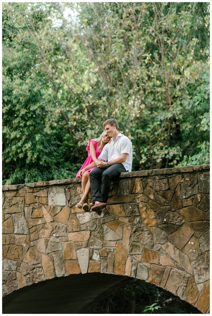 Couple cuddling on stone bridge