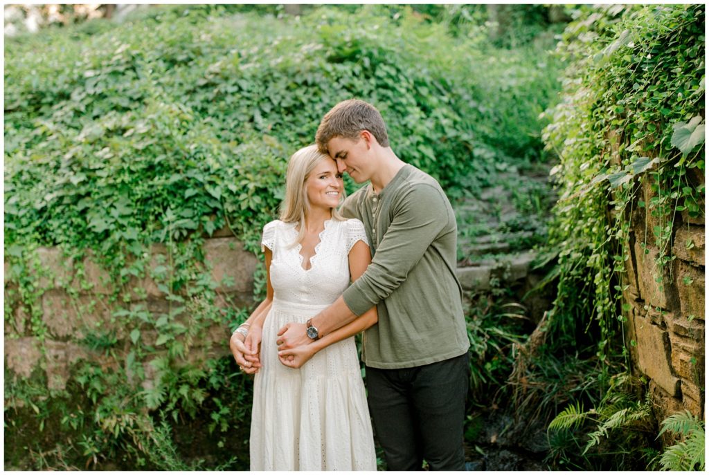 Guy hugging girl from behind holding her hands in Dallas engagement