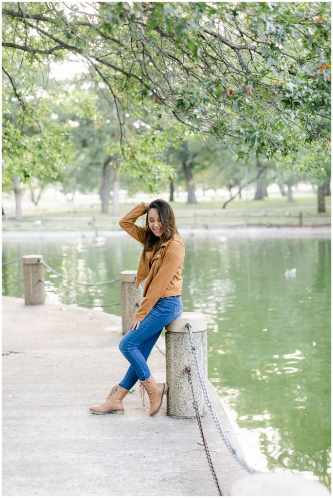 Girl under tree by lake in Fort Worth Trinity Park senior session