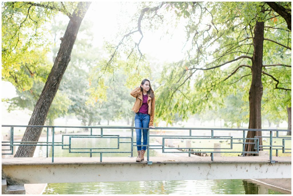 Girl standing on bridge over river