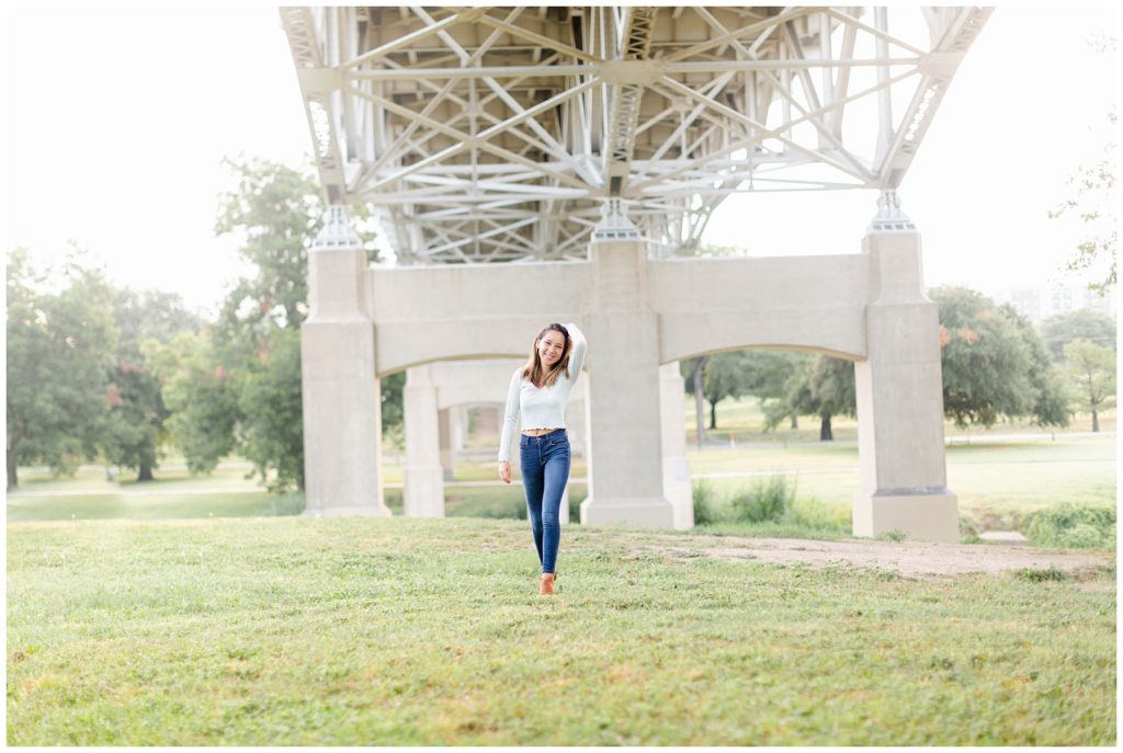 Girl standing under bridge in Fort Worth Trinity Park senior session