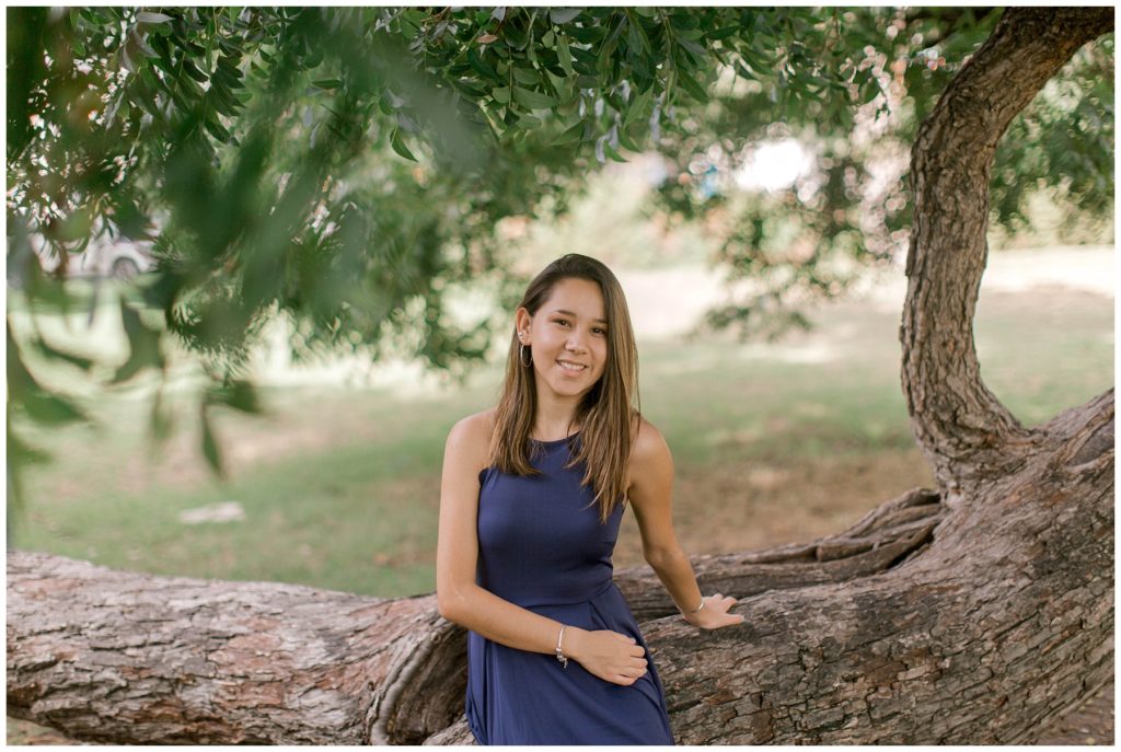 Girl in dress under large tree in Fort Worth Trinity Park senior session