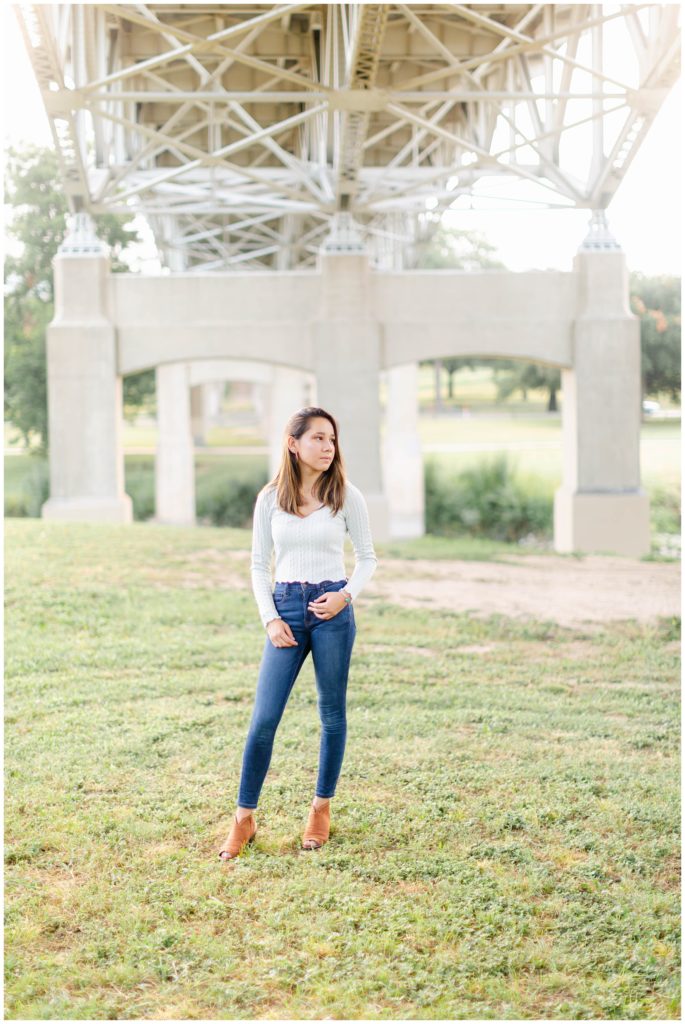 Girl standing under bridge in Fort Worth Trinity Park senior session