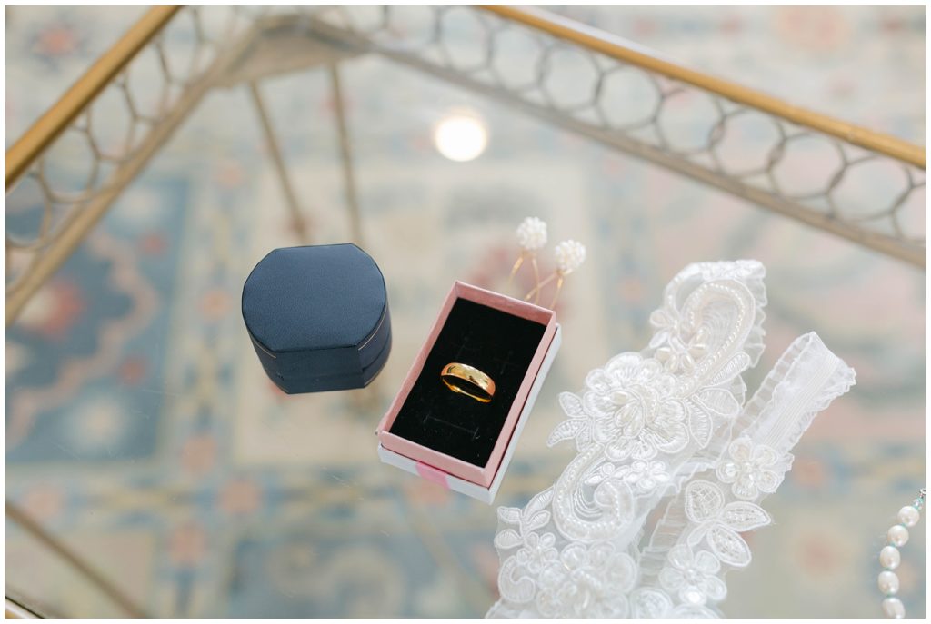 Wedding jewelry and garter on glass table