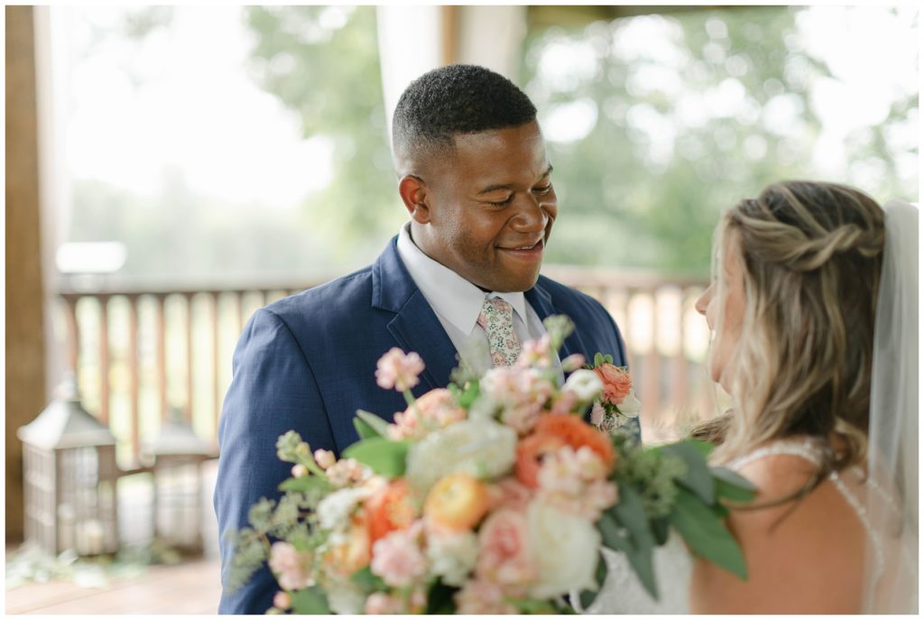 Groom looking at bride during first look