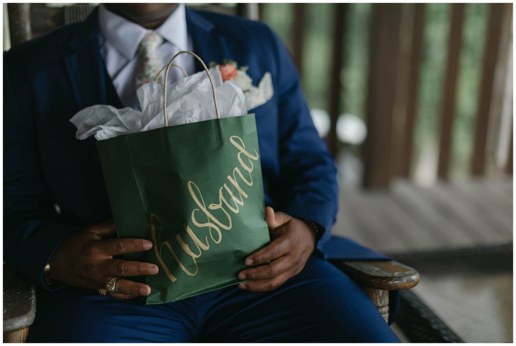 Groom holding gift from bride