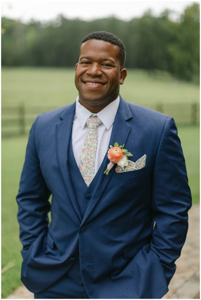 Groom standing at Pine Knoll Farms wedding venue