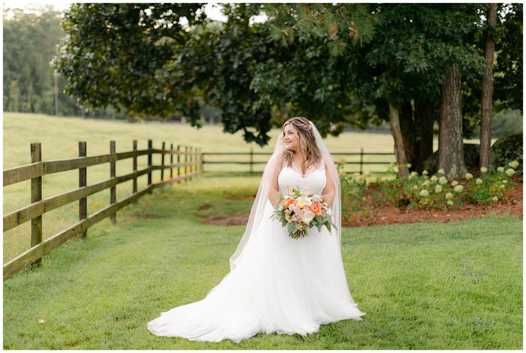 Bride standing in field at Pine Knoll Farms wedding venue