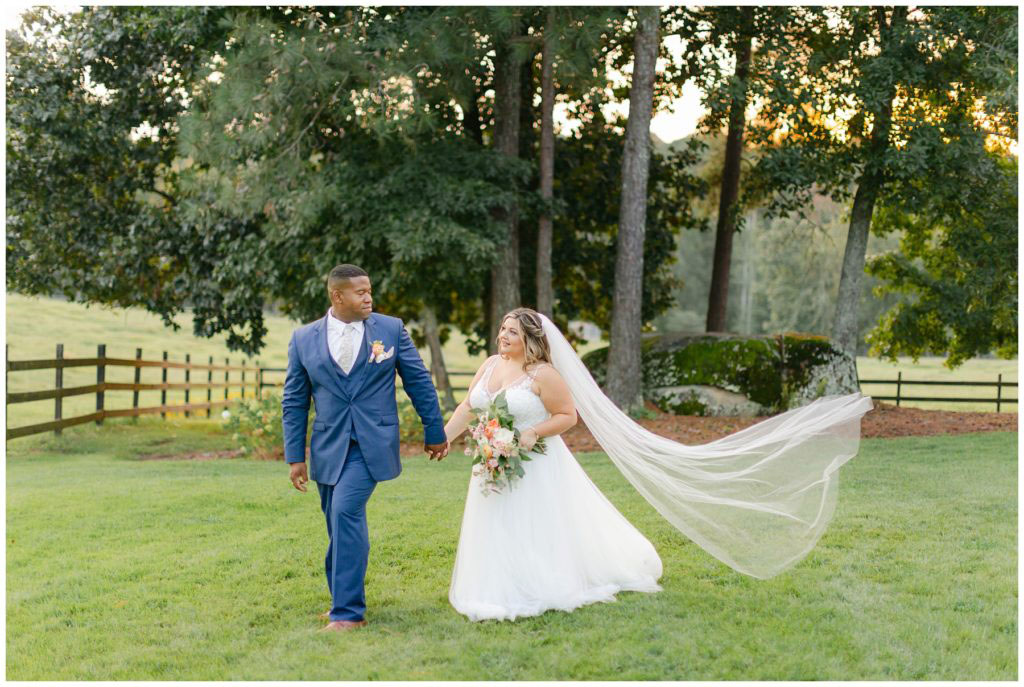 Bride and groom holding hands in Pine Knoll Farms wedding
