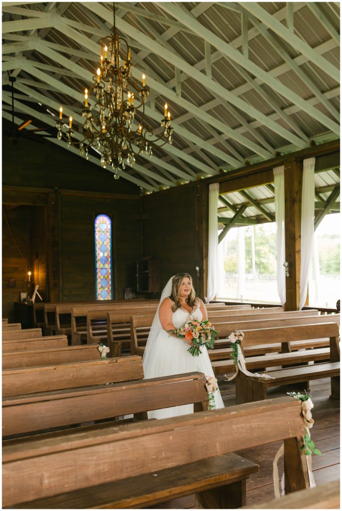 Bride walking up to groom for first look in The Kelly Chapel