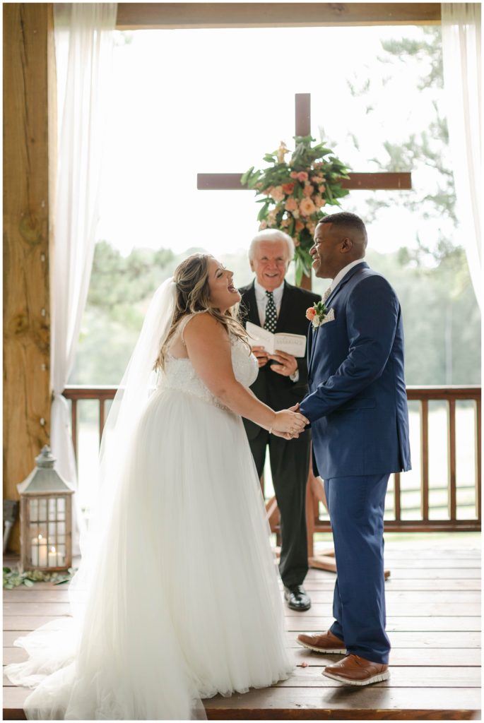 Bride and groom holding hands at alter in The Kelly Chapel