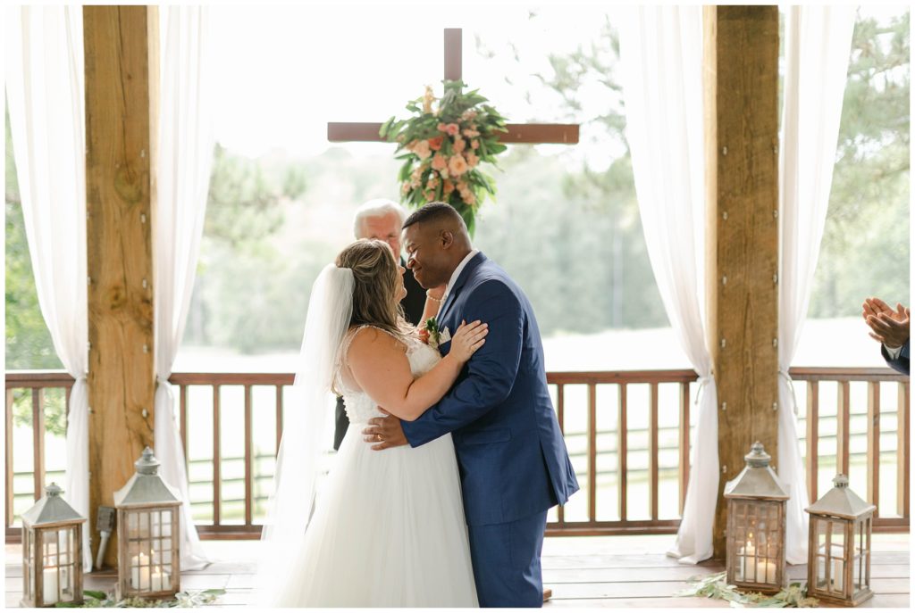 Bride and groom kiss at alter in The Kelly Chapel