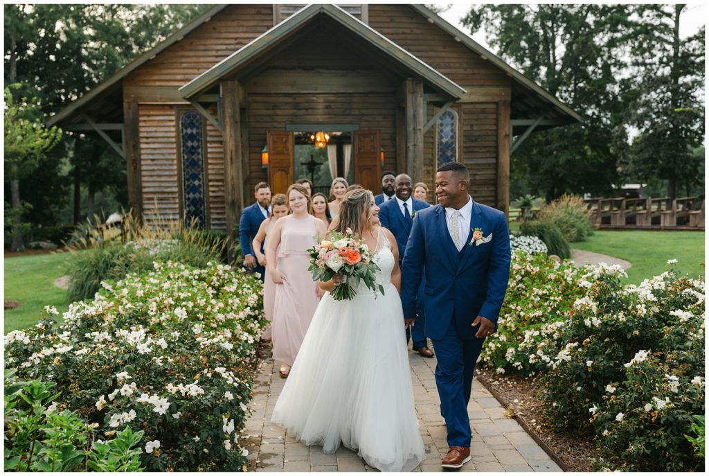 Wedding party walking out of the Kelly Chapel Pine Knoll Farms wedding