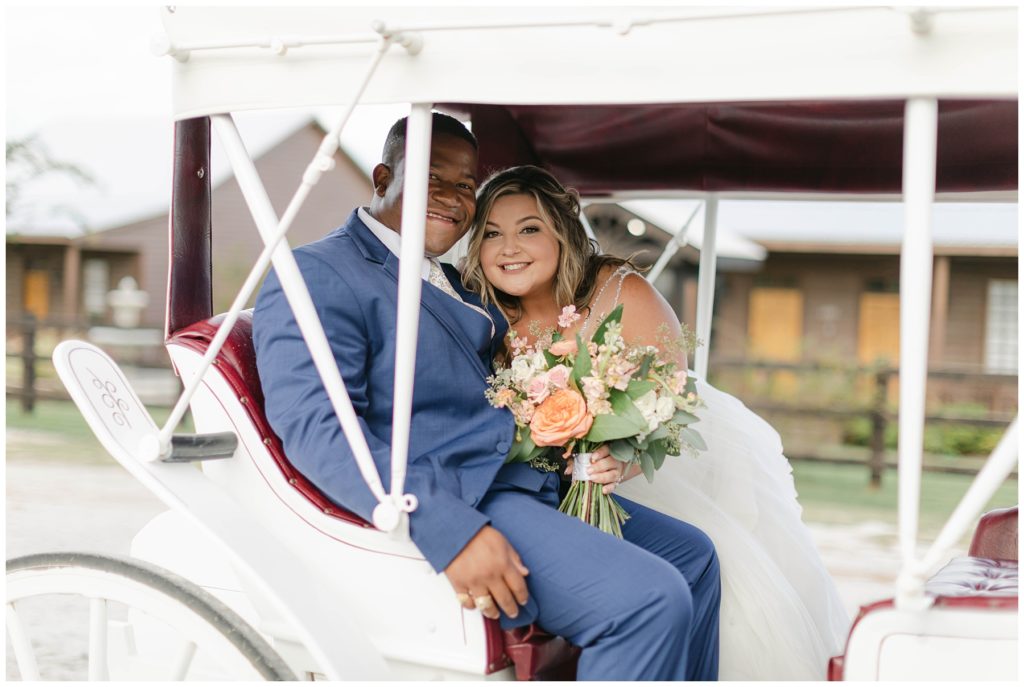 Bride and groom ride in wedding carriage