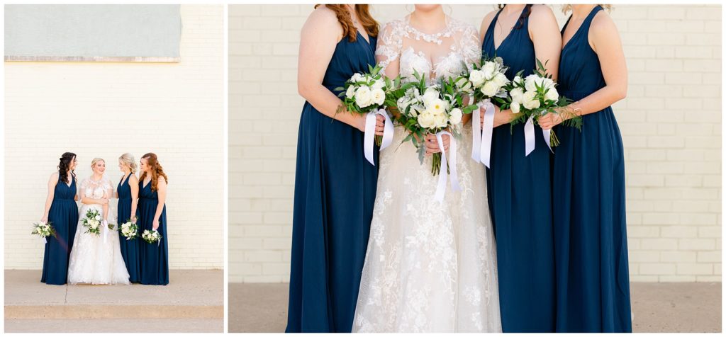 Bride standing with bridesmaids in navy gowns
