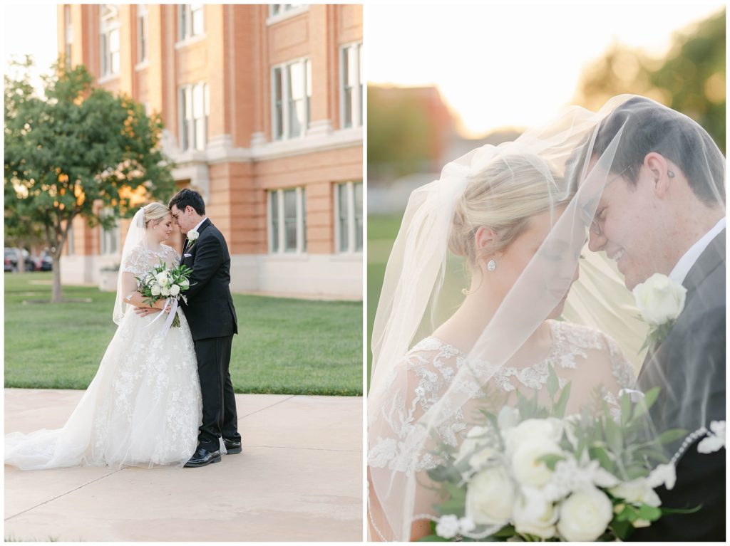 Bride and groom nuzzling under veil