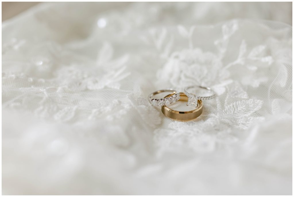 wedding rings laying on lace