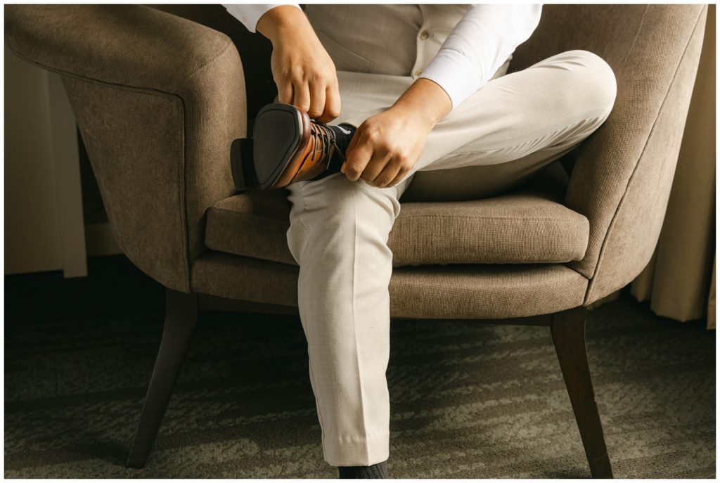 groom putting on shoes