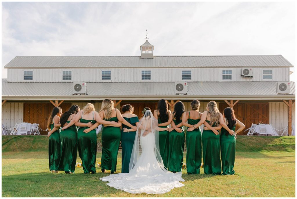 Bride and bridesmaids in big white barn wedding