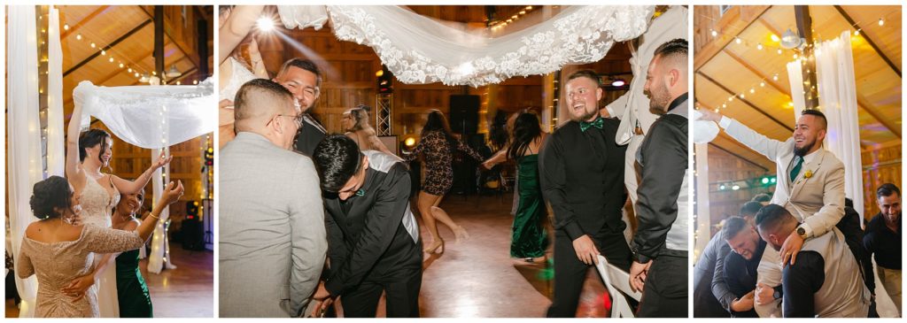 Bride and groom holding veil over wedding guests' heads