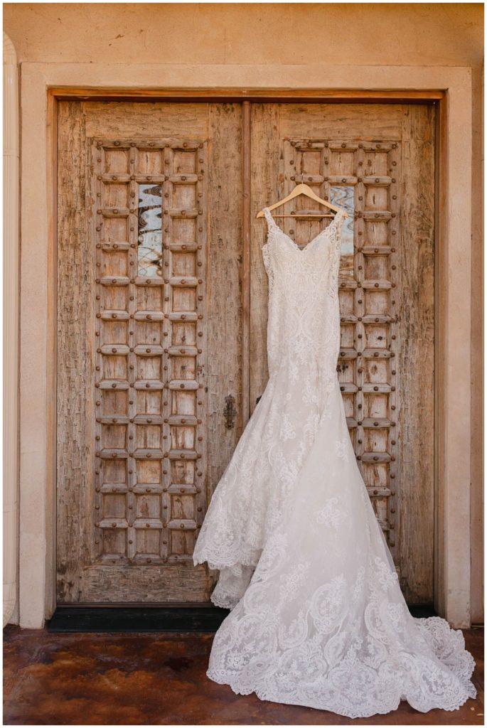 Dress hanging on doors of wedding chapel