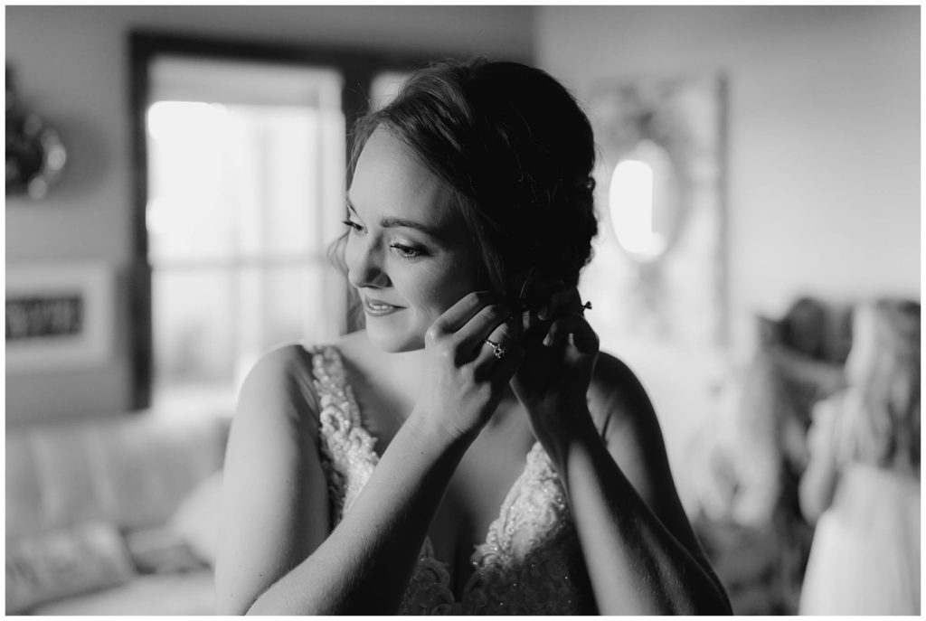 BW bride putting earring on