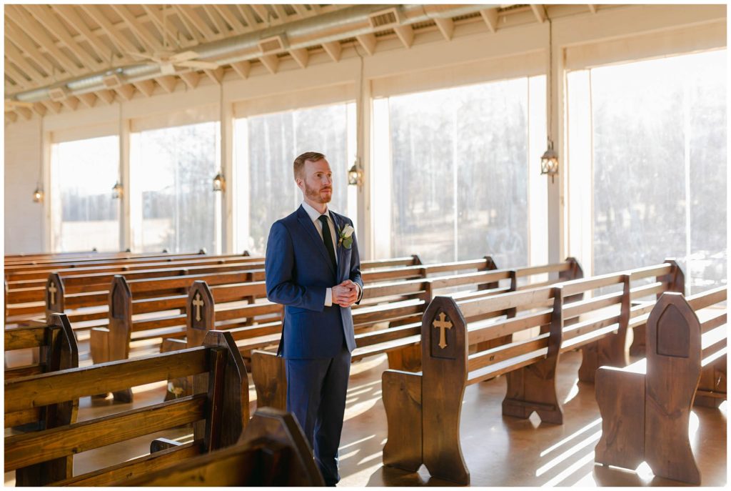 Groom waiting in chapel for bride first look
