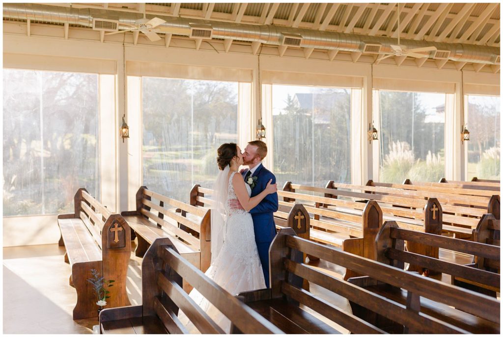 bride & groom kiss after first look at The Brooks at Weatherford wedding chapel