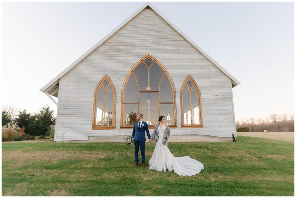 bride and groom standing in front of the brooks at Weatherford chapel