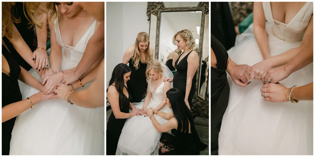 bridesmaids praying over bride