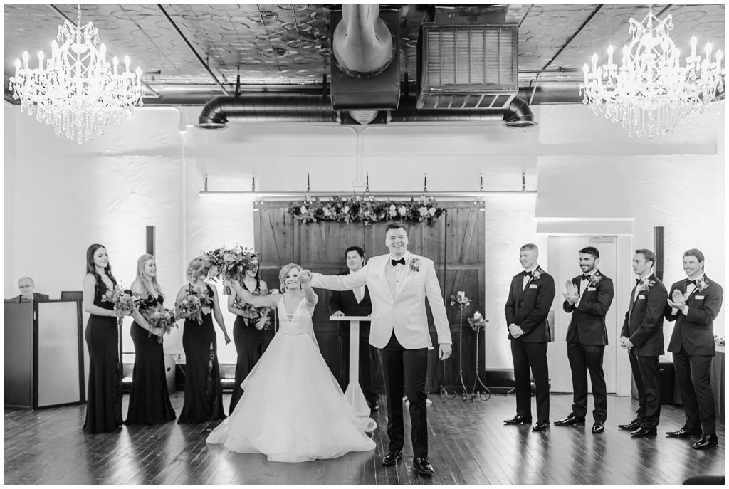 bw bride and groom hold hands after ceremony at Hugo's on the Square