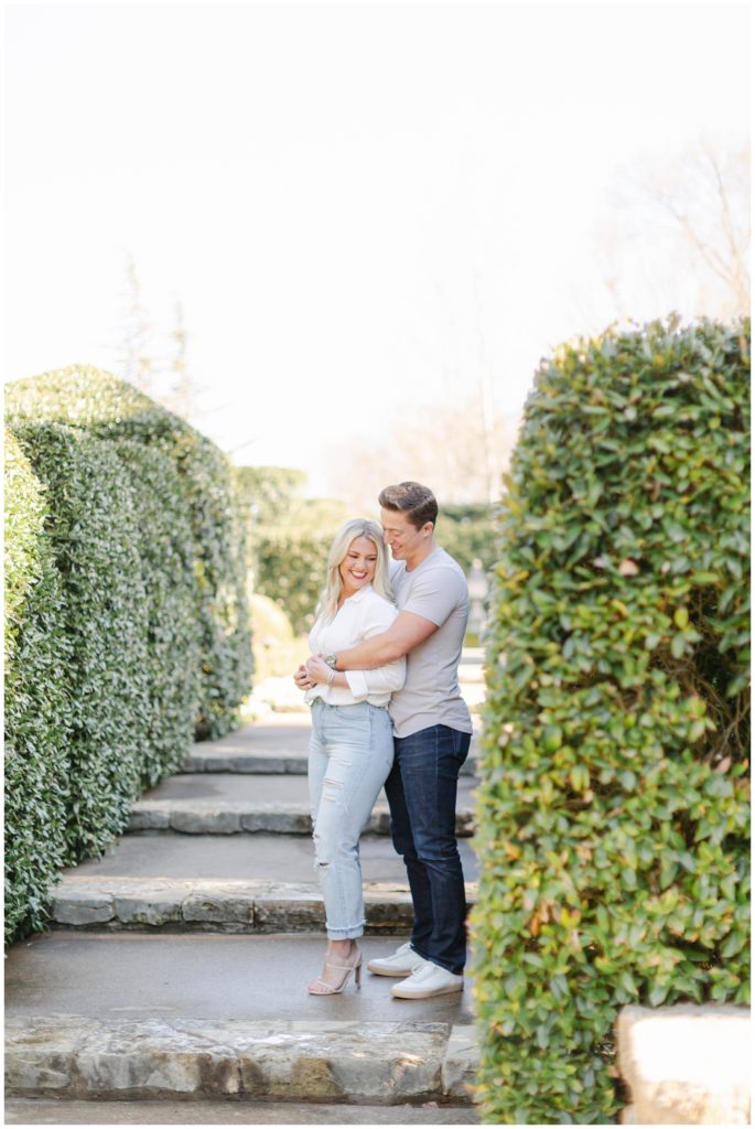 Guy hugging girl from behind on steps