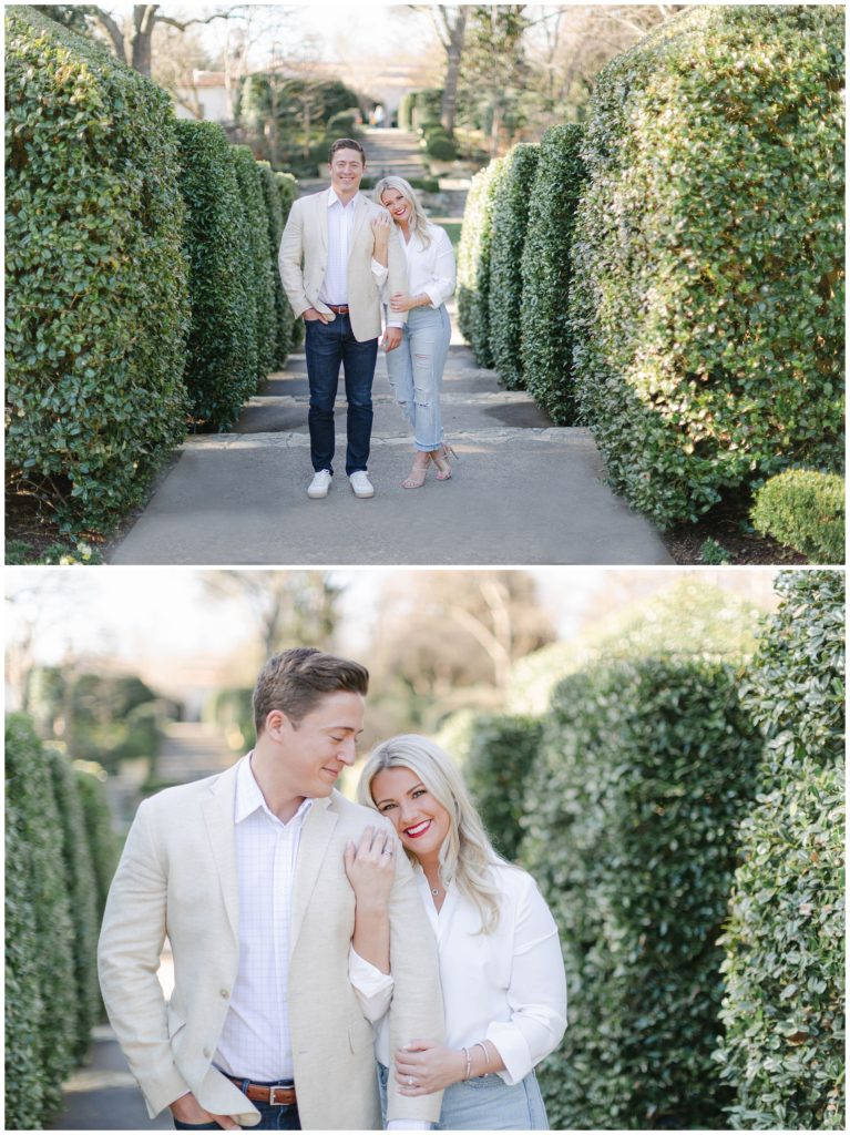 Engaged couple standing between hedges at Dallas Arboretum engagement session