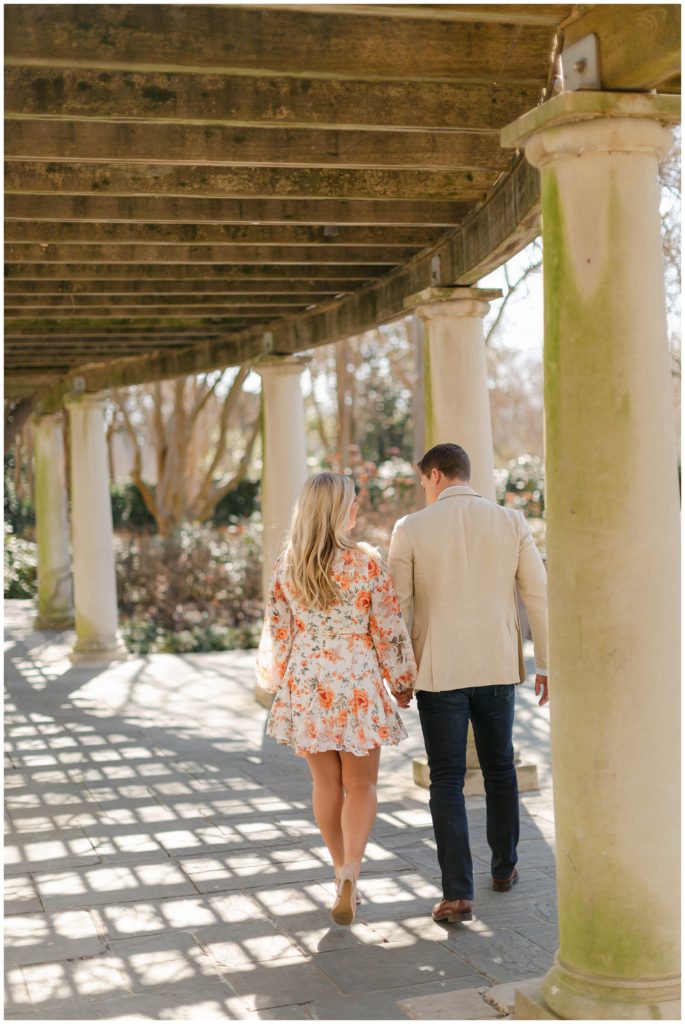 Couple walking under pergola