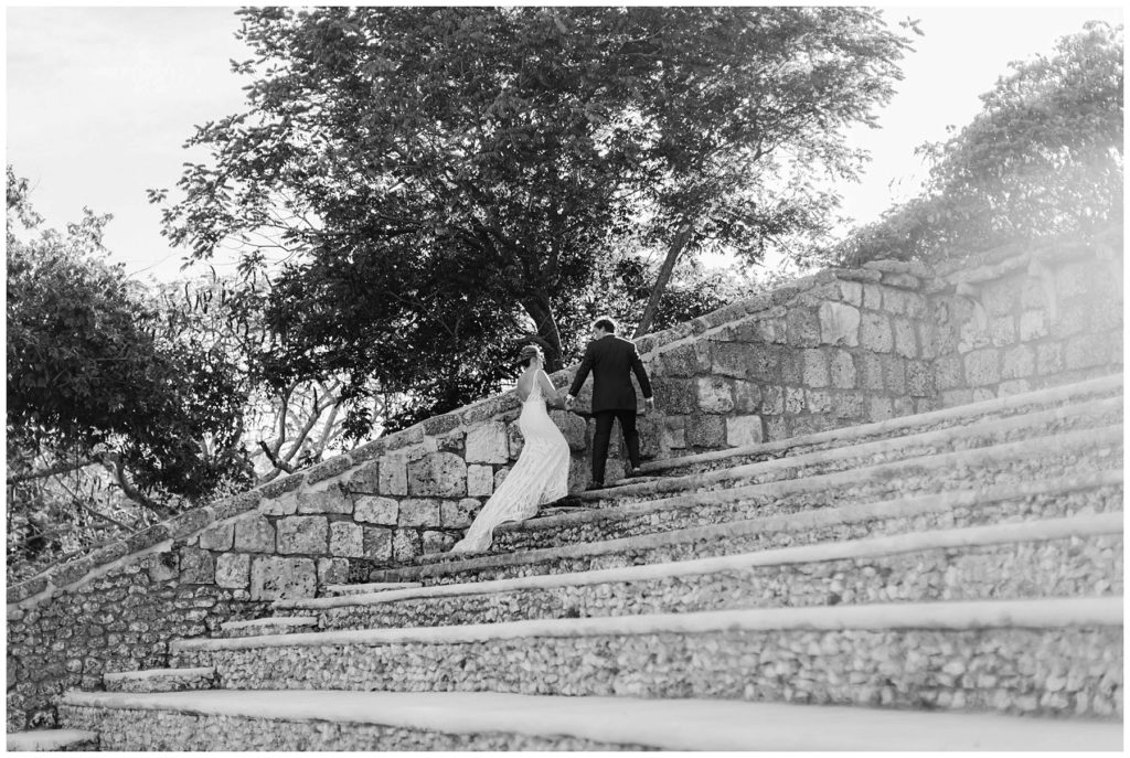 Bride and groom walking up steps at Ampitheater at Atlos de Chavon