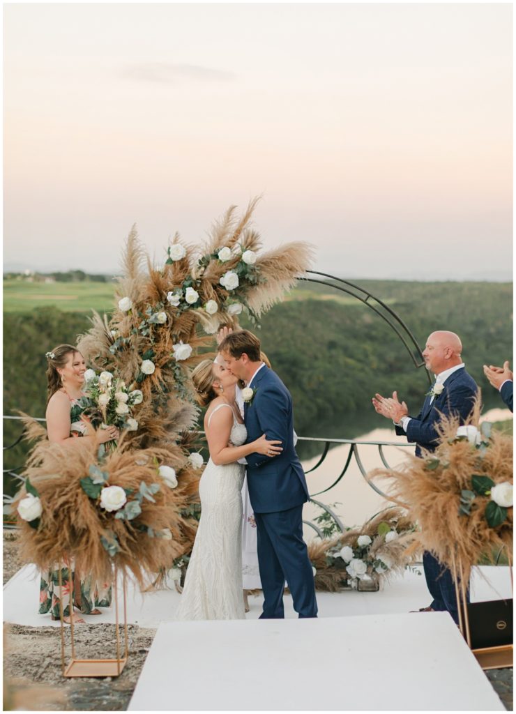 Bride and groom kiss at alter in Dominican Republic wedding