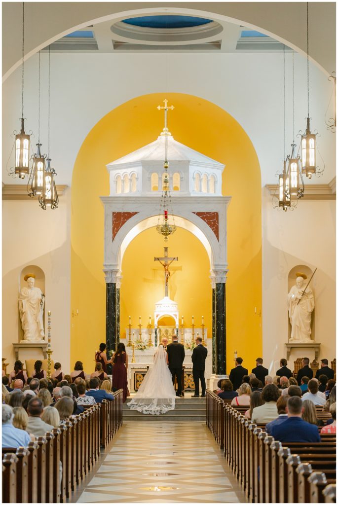 bride and groom standing at alter in South Carolina catholic wedding