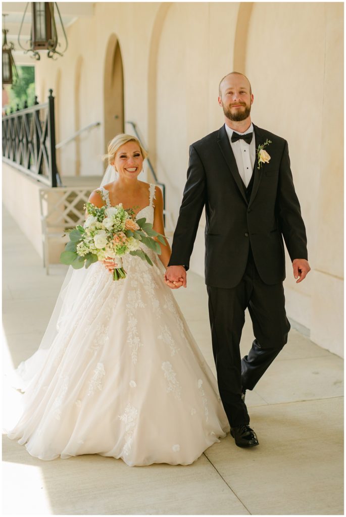 bride and groom walking hand in hand