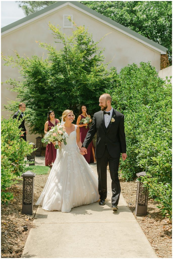 bride and groom walking hand in hand