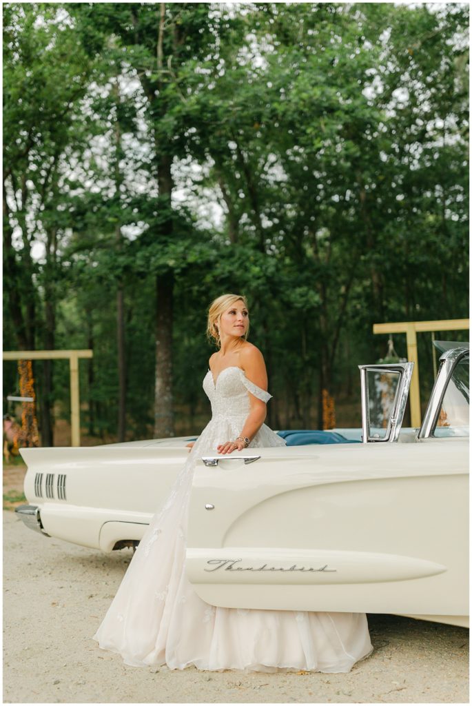 bride standing in front of white vintage car South Carolina Catholic wedding