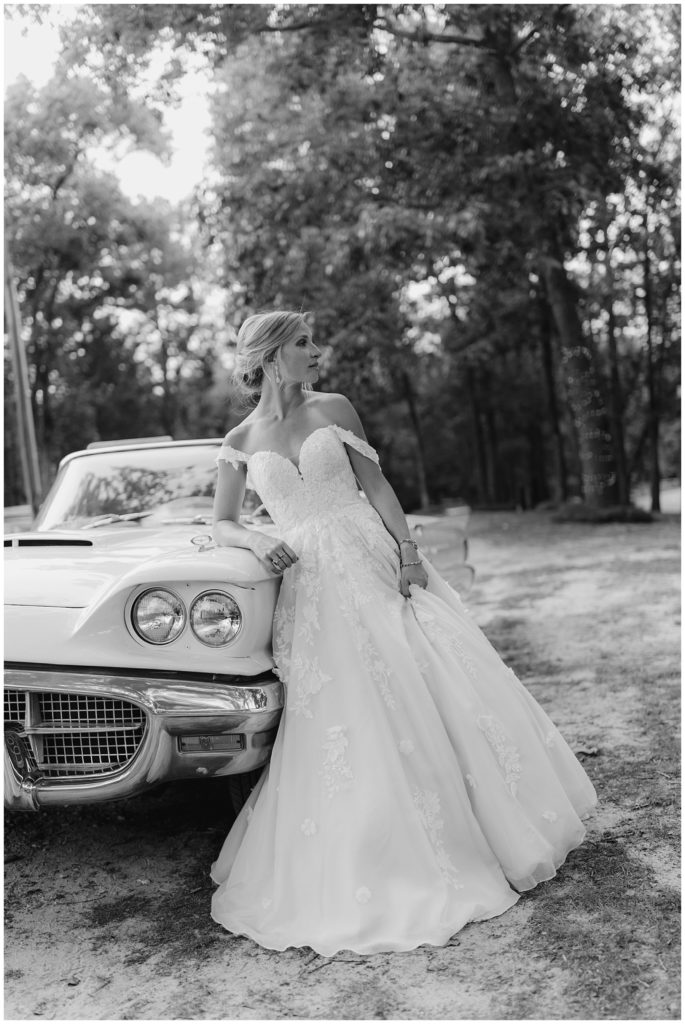 bride standing in front of white vintage car