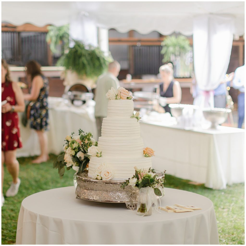 4 tiered white wedding cake with roses