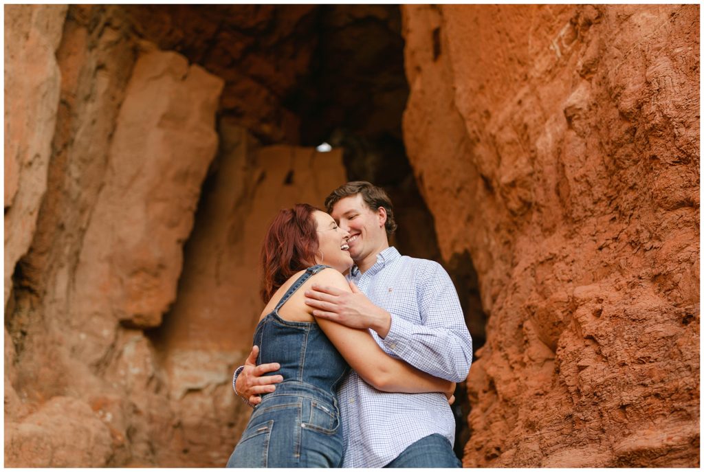 Couple hugging and laughing in canyon caves