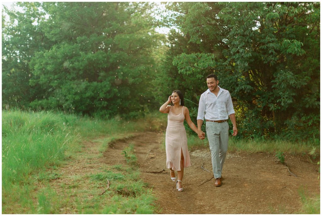 Couple walking in the rain Couple kissing in the rain in Arbor Hills Nature Preserve Engagement