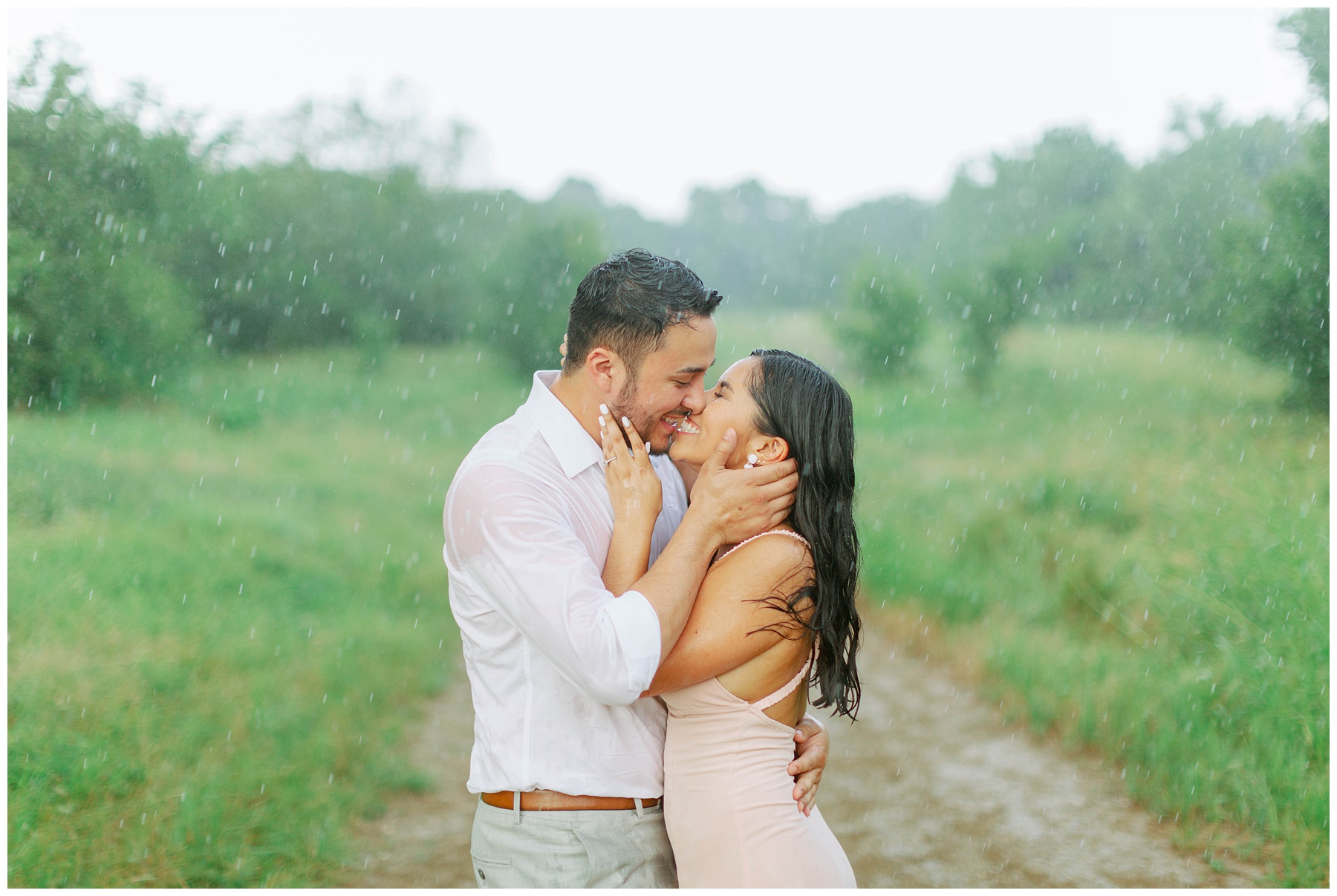 couple kissing in the rain Couple kissing in the rain in Arbor Hills Nature Preserve Engagement