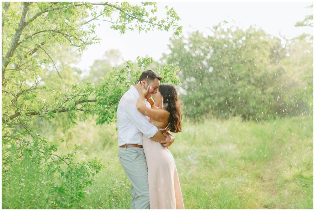 Couple kissing in the rain Couple kissing in the rain in Arbor Hills Nature Preserve Engagement