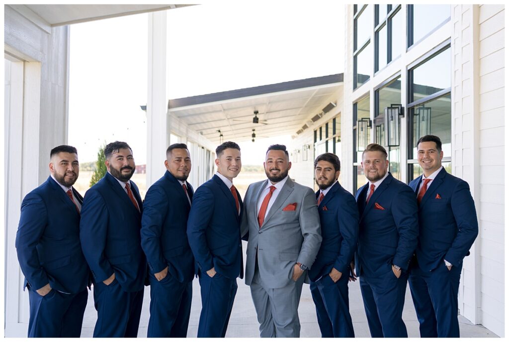 Groom standing with groomsmen