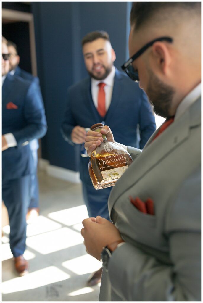 Groom and groomsmen having shots and cigars