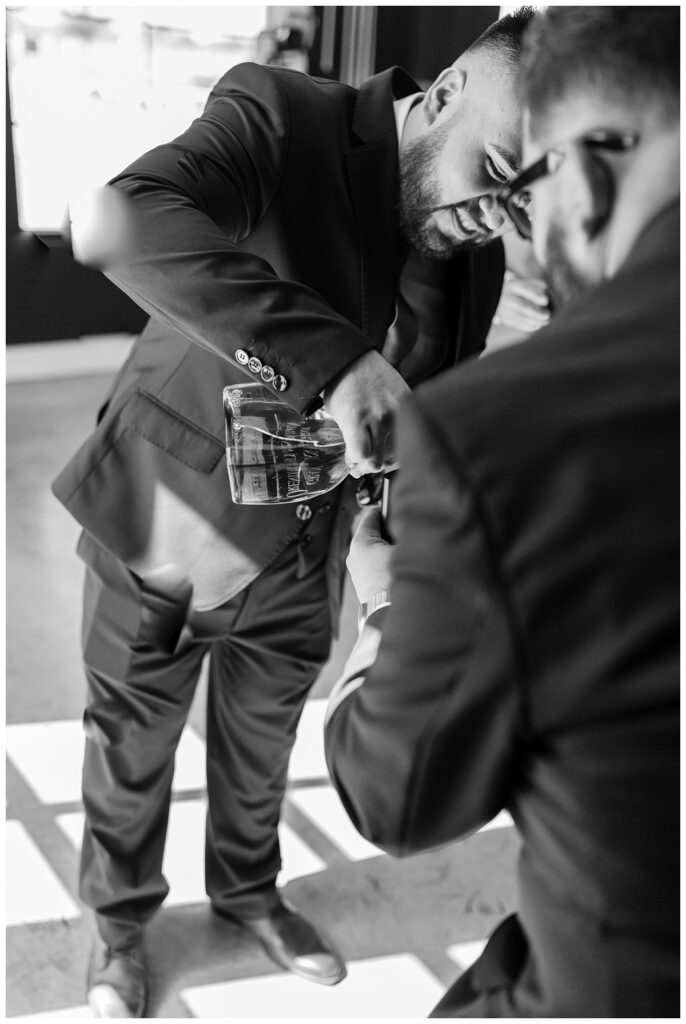 Groom and groomsmen having shots and cigars