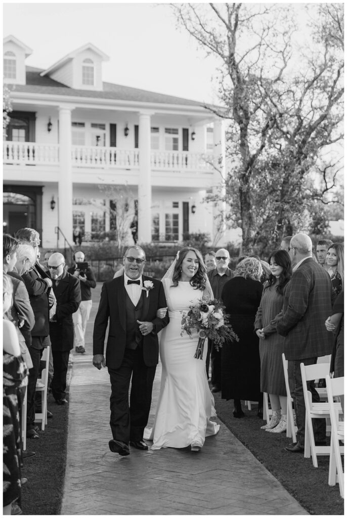 bride walking down aisle with father at The Springs in Weatherford